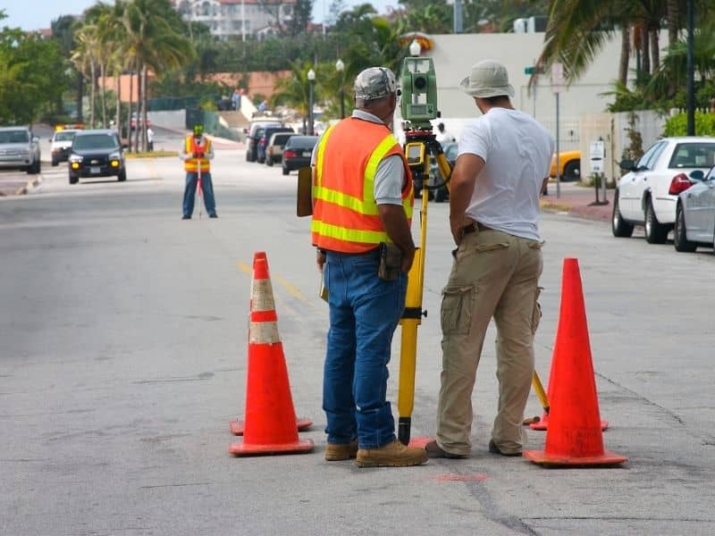 Construction survey crew setting control points on a road project to guide accurate layout and field work.